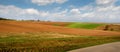 Spring areas of arable fields and winter wheat, lines and hills.