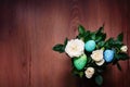 Spring arrangement of rose flowers with multi-colored Easter eggs Royalty Free Stock Photo
