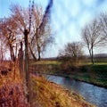 Spring autumn fence nature trauquil scene stream trees Royalty Free Stock Photo