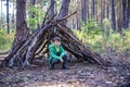 In the spring or autumn in the pine forest the boy plays he buil Royalty Free Stock Photo