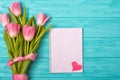 Spring background with bouquet of tulips and blank notebook for romantic entries.