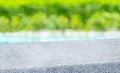 Spring background.Empty diagonal pebble grey stone table with blur tree and pond in garden boekh background,banner mockup template