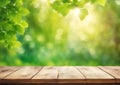 Spring background with green foliage and empty wooden table in nature. Beauty bokeh and sunlight. Royalty Free Stock Photo