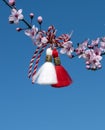 Spring background with pink blossom and Bulgarian symbol of spring - martenitsa. Spring flowers sakura. Greeting card