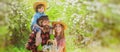 Spring banner with happy family. Cheerful family on picnic in a park. Family Farmers working in tree garden at spring Royalty Free Stock Photo