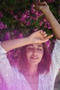 Spring beauty portrait stunning young woman posing in garden with pink flowers