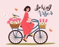 Spring bicycle trip. A woman rides a bicycle with flowers.