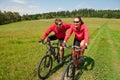 Spring bike - Young sportive couple in meadow Royalty Free Stock Photo