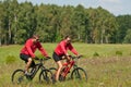 Spring bike - Young sportive couple in meadow Royalty Free Stock Photo