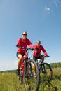 Spring bike - Young sportive couple in meadow Royalty Free Stock Photo