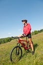 Spring bike - Young sportive woman in meadow