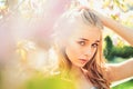 Spring bloom concept. Lady in park on spring day. Girl on dreamy face, tender blonde near violet flowers of judas tree Royalty Free Stock Photo