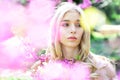 Spring bloom concept. Young woman enjoy flowers in garden, defocused, close up. Girl on dreamy face, tender blonde near Royalty Free Stock Photo