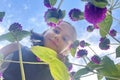 Spring blossom portrait of adorable young girl in pink summer flower against blue sky Royalty Free Stock Photo