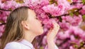 Spring in botany garden. That is how spring smells. Tender bloom. Little girl enjoy spring. Kid on pink flowers of Royalty Free Stock Photo