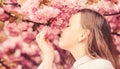 Spring in botany garden. That is how spring smells. Tender bloom. Little girl enjoy spring. Kid on pink flowers of Royalty Free Stock Photo
