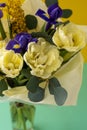 Spring bouquet of flowers. Irises, tulips, mimosa and eucalyptus. Yellow and blue flower. Bud close-up. Floral