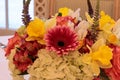 Spring bouquet of pink Gerbera daisies, yellow daffodils, orange roses, and green hydrangea