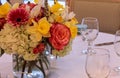 Spring bouquet of pink Gerbera daisies, yellow daffodils, orange roses, and green hydrangea