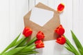 Spring bouquet of red tulips and a card in an envelope Royalty Free Stock Photo