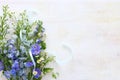 Spring bouquet of white and blue flowers over white vintage wooden background. top view, flat lay Royalty Free Stock Photo