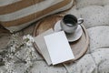 Spring breakfast scene. Blank greeting card, invitation mockup. Cup of coffee, round wooden tray. Blossoming cherry plum