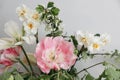 Spring bridal bouquet of mixed garden flowers on vintage gray wall background behind. Closeup of pink tulip, daffodils Royalty Free Stock Photo