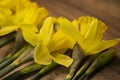 Daffodils narcissus Easter composition laying on a wooden board table, close up