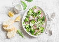 Spring broccoli and radish salad with yogurt sauce on a light background, top view. Delicious healthy vegetarian food Royalty Free Stock Photo