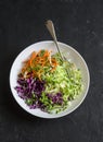 Spring cabbage salad with sour cream and micro greens. Healthy vegetarian diet food concept. On a dark background