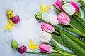 Spring card with empty paper blank. Easter Background with tulips, quail eggs. Top view, flat lay Royalty Free Stock Photo