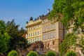 Spring cityscape of Prague with beautiful architecture, green trees and blue sky