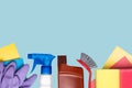 Spring cleaning background. Close-up of house cleaning products and cleaning supplies over light blue background. Household chore