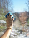 Spring cleaning - cleaning windows. Women`s hands wash the window, cleaning Royalty Free Stock Photo