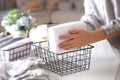 Spring cleaning of closet. Vertical tidying up storage. Neatly folded clothes in the metal black baskets for wardrobe. Nordic