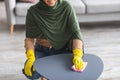 Closeup of young muslim woman cleaning table with cloth Royalty Free Stock Photo