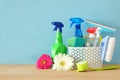 Spring cleaning concept with supplies on wooden table. Royalty Free Stock Photo