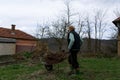 Spring Cleaning in the Countryside: Female Farmer and Her Wheelbarrow. Royalty Free Stock Photo