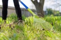 Spring cleaning in the garden, closeup rake cleaning green grass