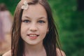 Spring closeup outdoor portrait of adorable 11 years old preteen kid girl