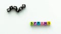 Spring coming and changing winter. Spring concept. Colorful letter beads on white background.