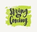 Spring Is Coming lettering written with elegant cursive font or script on green paint smear isolated on white background