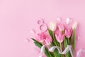 Spring composition with bouquet of tulip flowers on pastel pink table top view. Greeting card for 8 March International Women Day. Royalty Free Stock Photo