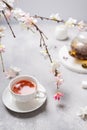 Spring composition. Cup of black tea and sakura branches. Tea party, poster, menu, greeting card concept. Copy space Royalty Free Stock Photo