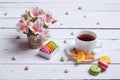 Spring composition: a cup of tea, almond cookies, bright flowers Royalty Free Stock Photo