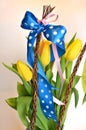 Spring composition: two easter whips with bunch of yellow tulips