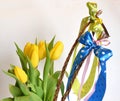 Spring composition: two easter whips with bunch of yellow tulips