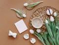 Spring composition. White tulips, coffee cup, candle