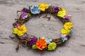 Spring composition of a wreath of birch branches and craft colorful flowers