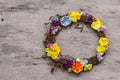 Spring composition of a wreath of birch branches and craft colorful flowers